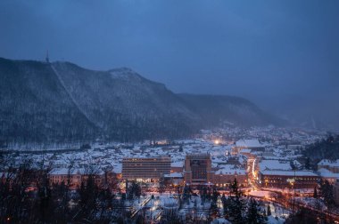 Celebrate the magic of New Year in Brasov, Romania, with this vibrant scene of Piata Sfatului illuminated by festive lights, a majestic Christmas tree, and dazzling fireworks. The iconic clock tower and traditional market stalls create an enchanting clipart