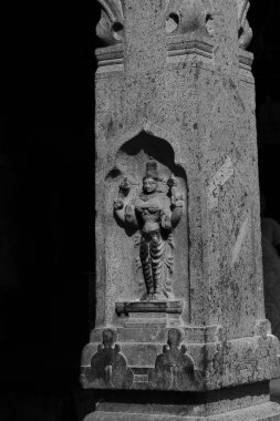 A striking black-and-white capture of a statue adorning a Hindu temple, highlighting its intricate design and timeless spiritual significance. clipart