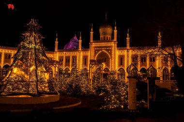 Night view of Tivoli Gardens lit up with stunning Christmas lights, creating a magical holiday atmosphere. clipart