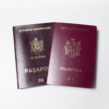 Close-up of Moldavian and Romanian passports isolated on white background.