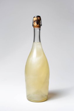 Close-up of champagne bottle on white background. Unusual cocktail drink.