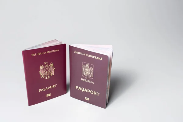 Close-up of Moldavian and Romanian passports isolated on white background.