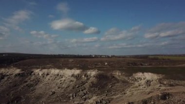 Aerial view of white rock hills in sunny day with blue sky. Natural background. Man near car on the peak.