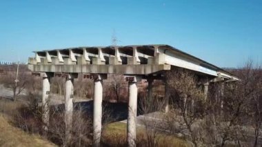 Aerial view of unfinished part of viaduct. Abandoned city road bridge. Drone video.