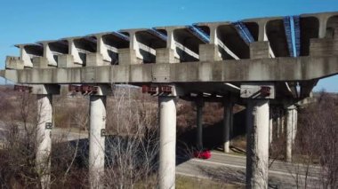 Aerial view of unfinished part of viaduct. Abandoned city road bridge. Drone video.