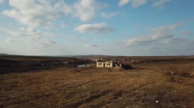 Abandoned house in dirty field. Aerial view.