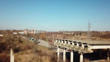 Aerial view of unfinished part of viaduct. Abandoned city road bridge. Drone video.