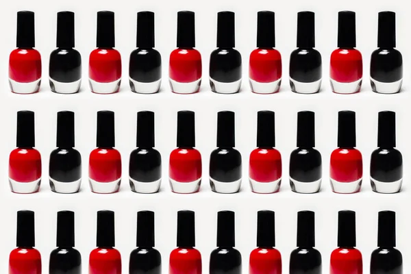 Pattern of glitter nail polish of black and red color's isolated on white background.