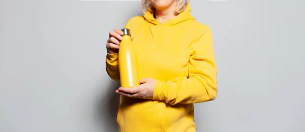 Γυναίκα Κρατώντας Μεταλλικό Θερμοφόρα Μπουκάλι Νερό Λευκό Φόντο Κίτρινο Χρώμα — Φωτογραφία Αρχείου