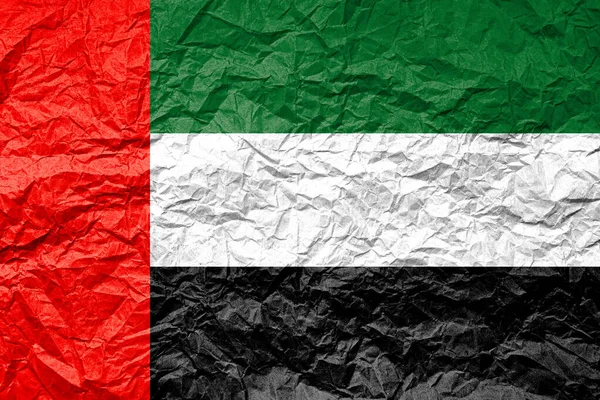Flag of United Arab Emirates on crumpled paper. Textured background.