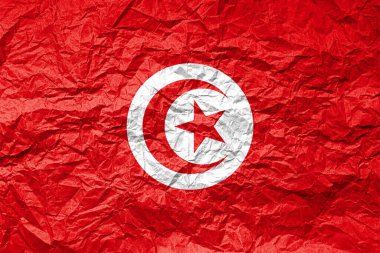 Buruşmuş kağıt üzerinde Tunus bayrağı. Desenli arkaplan.