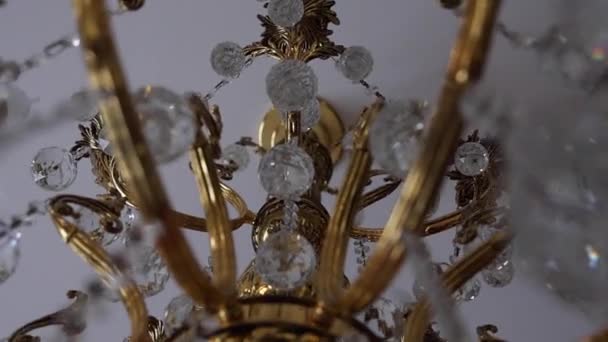 stock video Close-up view of golden crystal classic chandelier.