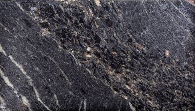 Kara Orman graniti yüksek parlatılmış bir taştır. Kara mermer arkaplanının dokusu. Yüksek çözünürlüklü siyah Marquina desenli mermer levhalar. İç dekorasyon için koyu gri marbel.