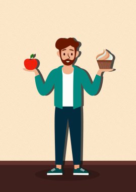 Bir adam elinde bir elma ve bir kek tutuyor. Gülümsüyor ve iki şeyi karşılaştırıyor gibi görünüyor.