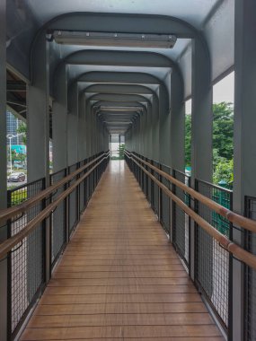 Ahşap zeminli ve fütüristik çatılı koridor.