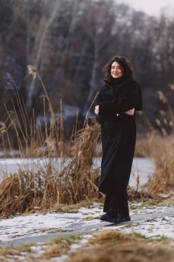A beautiful girl walks on a sunny winter day 
