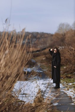 A beautiful girl walks on a sunny winter day 
