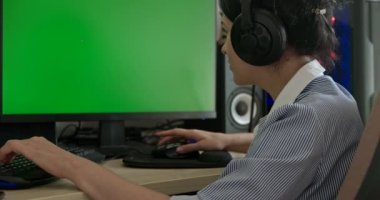 Young Woman Playing Game on Desktop PC Computer Green Screen Monitor. Gamer Sit at Desk Table 4K 10 bit