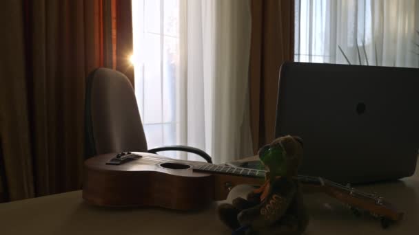 Ukulele Guitar Music Instrument Teddy Bear Laptop Desk Sunshine Window — Vídeos de Stock