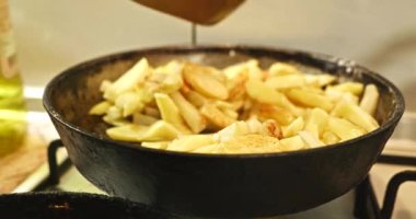 Cooking Fried Potato on Frying Pan Cooking on Vintage Gas Stove. Slow motion 60 fps 4K 10 bit