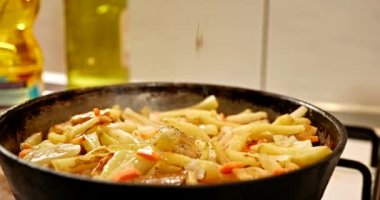 Seasoning Fried Potato Cooking on Frying Pan Cooking on Vintage Gas Stove in Kitchen. Slow motion 4K 10 bit