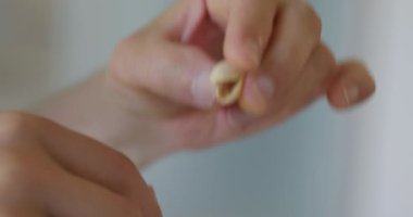 Adam Fıstık ve Ceviz Yiyiyor Mutfakta oturuyor. Yavaş çekim 60 fps 4K 10-bit