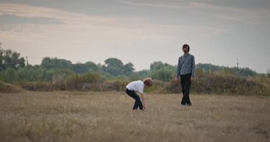 İnsan ve Çocuk frizbi fırlatıyor. Baba ve Çocuk Birlikte Oynuyor Doğa 4K 10-bit 'te Zaman Geçiriyorlar