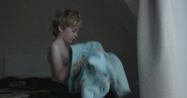 Boy Getting Dressed on Bed After Sleep 4K 10-bit