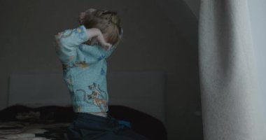 Boy Getting Dressed on Bed After Sleep 4K 10-bit