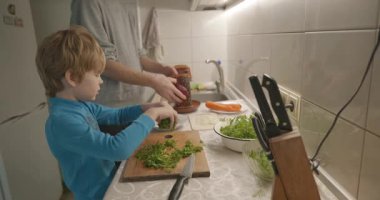 Boy Helps To Cook. Kid Prepare Food in Kitchen 4K 10-bit