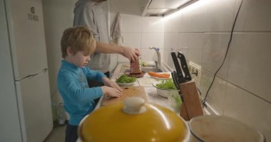 Boy Helps To Cook. Kid Prepare Food in Kitchen 4K 10-bit