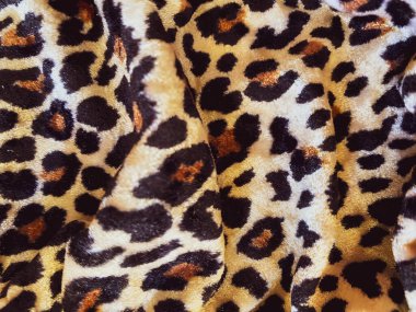 Leopar desenli, kadife gibi kadifemsi bir kumaş. Çita kadife kumaş. Tekstil arkaplanı