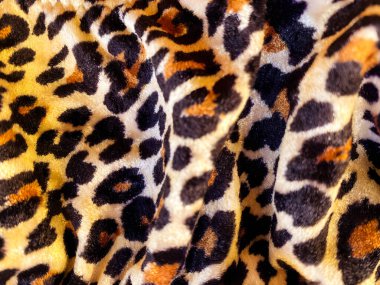 Leopar desenli, kadife gibi kadifemsi bir kumaş. Çita kadife kumaş. Tekstil arkaplanı