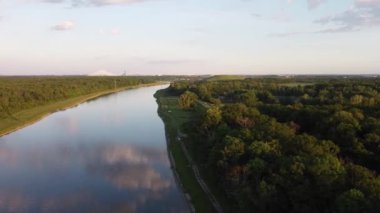 Nehrin üzerinde uçan yatay bir dron. Yazın güzel bir orman manzarası ve yeşil bir çevresi var.