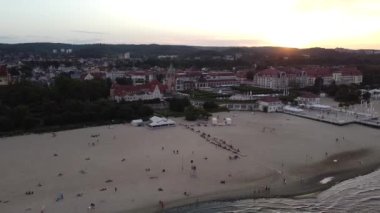 Akşamları bir turist kasabasında kumsal boyunca uçan bir insansız hava aracı.