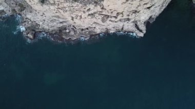 İHA İspanya 'da Akdeniz' in üzerindeki bir uçurumun yanında uçuyor.