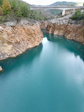 reservoir with emerald water rocky shore clipart