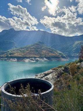 reservoir water tank mountains autumn sky. High quality photo clipart