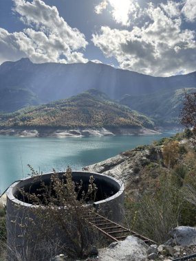 reservoir water tank mountains autumn sky. High quality photo clipart