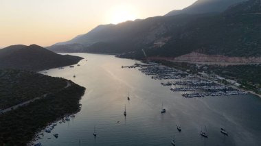 Kıyı dağı manzarası, deniz tatil yatları, altın saat.