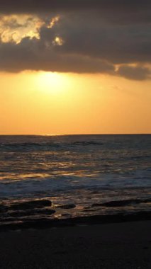 Gün batımında kıyı manzarası. Okyanus sahilinde gün batımı. Dalgalar, deniz köpüğü. Gün batımında Rocky Shore. - Evet. Yüksek kalite 4k görüntü