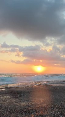 Gün batımında kıyı manzarası. Okyanus sahilinde gün batımı. Dalgalar, deniz köpüğü. Gün batımında Rocky Shore. - Evet. Yüksek kalite 4k görüntü