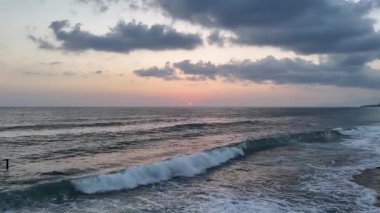 Gün batımında kıyı manzarası. Okyanus sahilinde gün batımı. Dalgalar, deniz köpüğü. Gün batımında Rocky Shore. - Evet. Yüksek kalite 4k görüntü