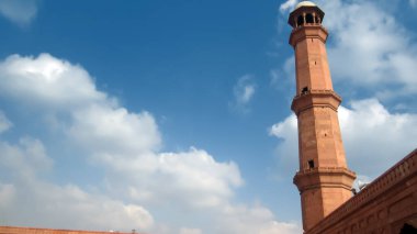 Minaret of badshahi mosque with cloudy sky in background clipart