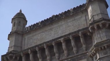 Mumbai Gateway of India stone archway close-up with inscriptions commemorating
