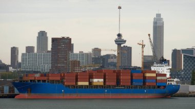 Rotterdam, Hollanda - Konteynırlarla dolu konteyner gemisi ve arka planda Rotterdam şehir merkezi