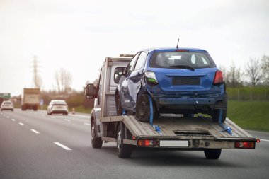 Trafik kazasından sonra hasarlı bir araçla çekilen aracın yan görüntüsü. Acil yol yardımı..