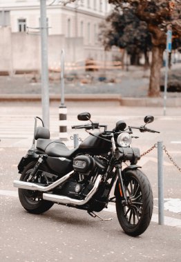 A black modern motorcycle is parked on the street next to a pedestrian cross. Prohibited parking of the vehicles. Parking violations. clipart