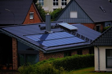 Kiel, Germany - 07 30 2023: House with solar panels on the roof. Nature-produced energy. Sun-produced energy. Photovoltaic systems on the barn house in the countryside. Concept of renewable energy clipart