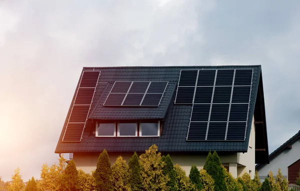 House with solar panels on the roof. Nature-produced energy. Sun-produced energy. Photovoltaic systems on the barn house in the countryside. Concept of renewable energy